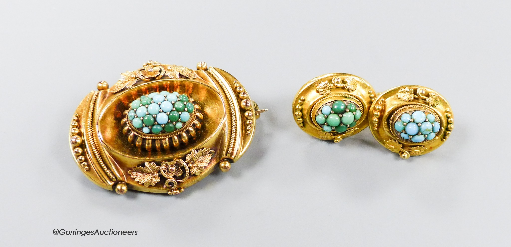 A Victorian yellow metal and turquoise set demi parure, comprising an oval brooch, 37mm and pair of ear clips, gross 11.2 grams, in Boodles & Dunthorne box.